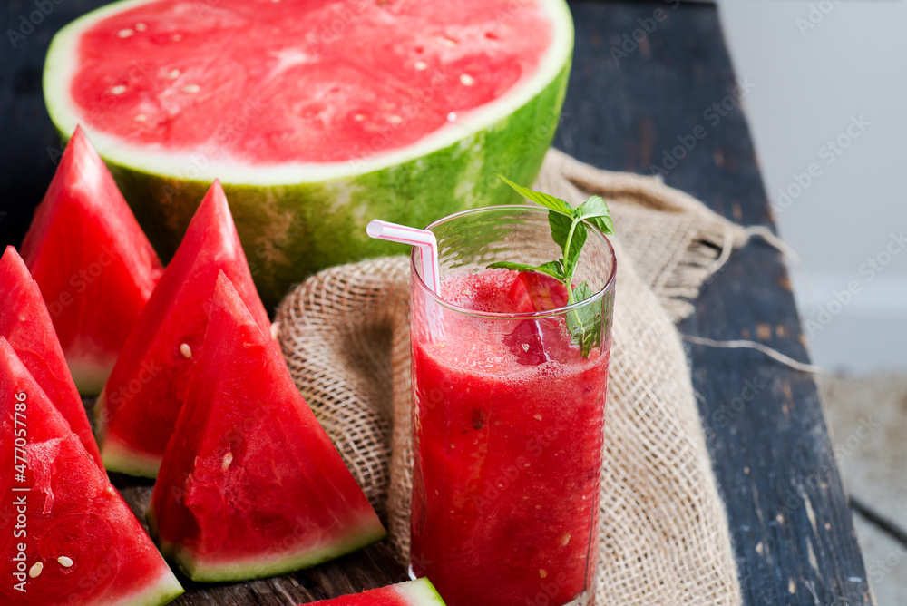 Fresh yummy delicious watermelon juice and watermelon slices on burlap. Fresh yummy delicious watermelon juice and watermelon slices on burlap.