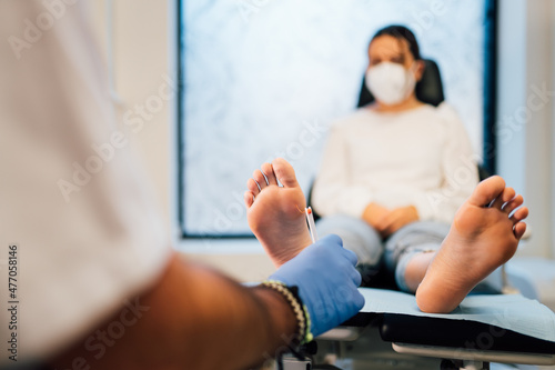 Chiropodist exploring a patient with diabetic foot in the medical center. photo