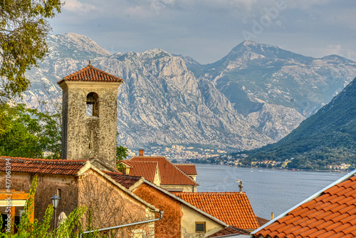 View of Perast,overlooking St.Nicholas church with bay and mountains beyond,Montenegro,Eastern Europe.