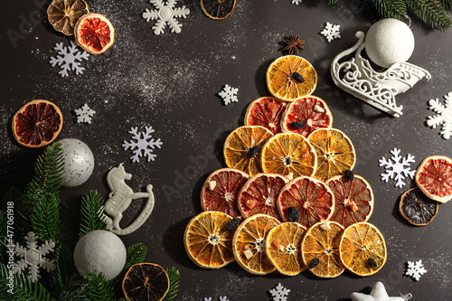 Festive fir tree from dried fruits. Christmas or New Year festive flat lay, food creative