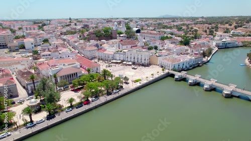 Aerial view of Tavira, Portugal, Algarve coast by Ria Formosa Natural Park. A Portuguese town with Medieval Castle, Santa María do Castelo Church and Ponte Romana de Tavira by the Gilão River in 4K.
