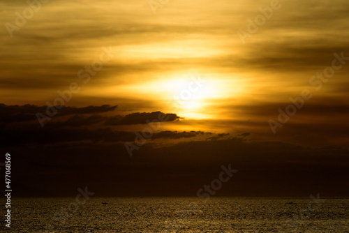 Beautiful sunset with glistening seas and romantic clouds.  © Jim