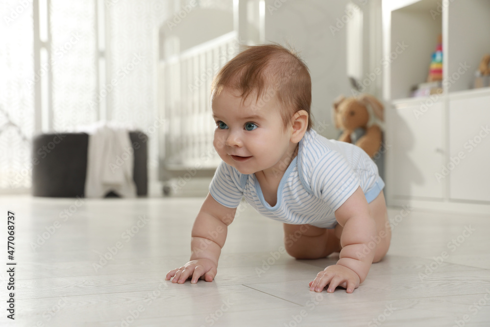 Cute baby crawling on floor at home Cute baby crawling on floor at home
