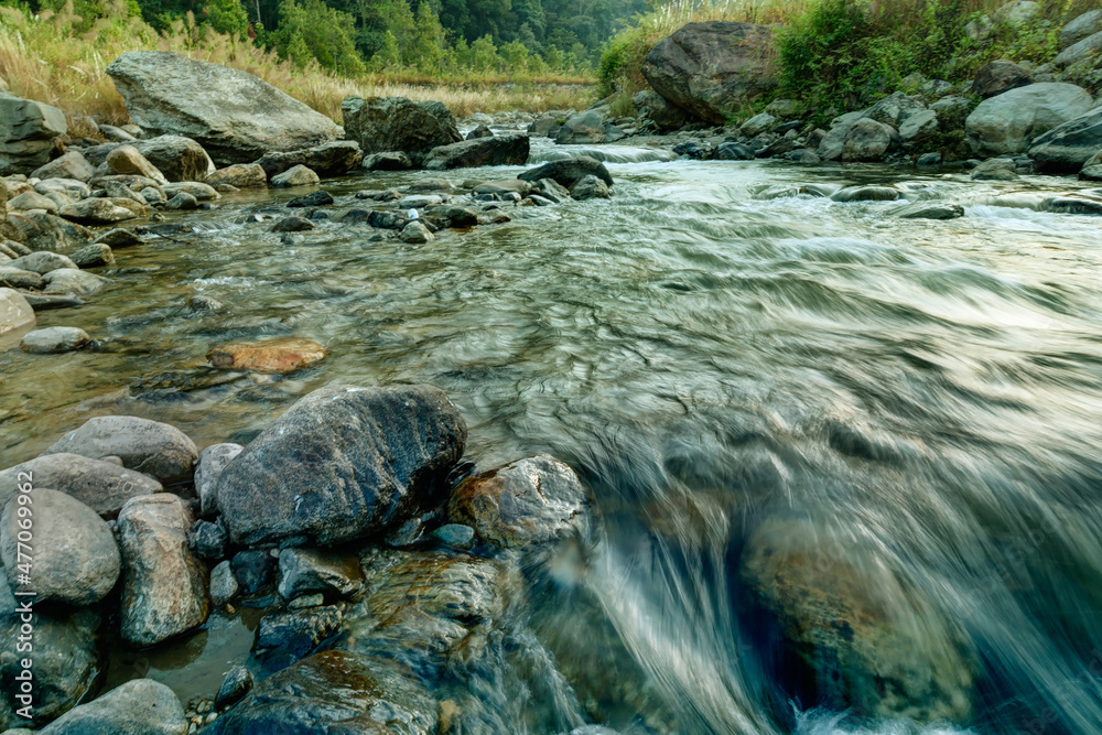Beautiful Reshi River water flowing on rocks at dawn, Sikkim, India - a spectacular view , tinted image Beautiful Reshi River water flowing on rocks at dawn, Sikkim, India - a spectacular view , tinted image