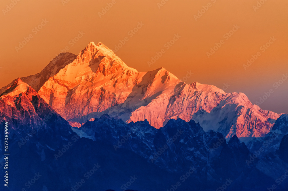 Beautiful first light from sunrise on Mount Kanchenjugha, Himalayan mountain range, Sikkim, India. Orange tint on the Himalayan mountains at dawn