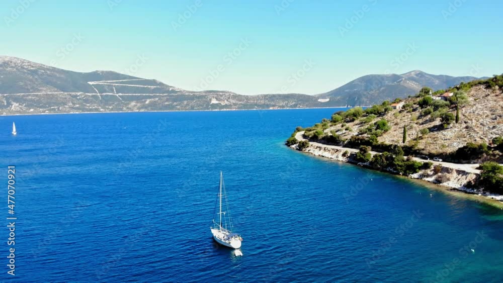 Tranquil Scenery of a Sailboat Sailing on the Blue Ocean of Agia Sofia in Greece - aerial drone shot Tranquil Scenery of a Sailboat Sailing on the Blue Ocean of Agia Sofia in Greece - aerial drone shot