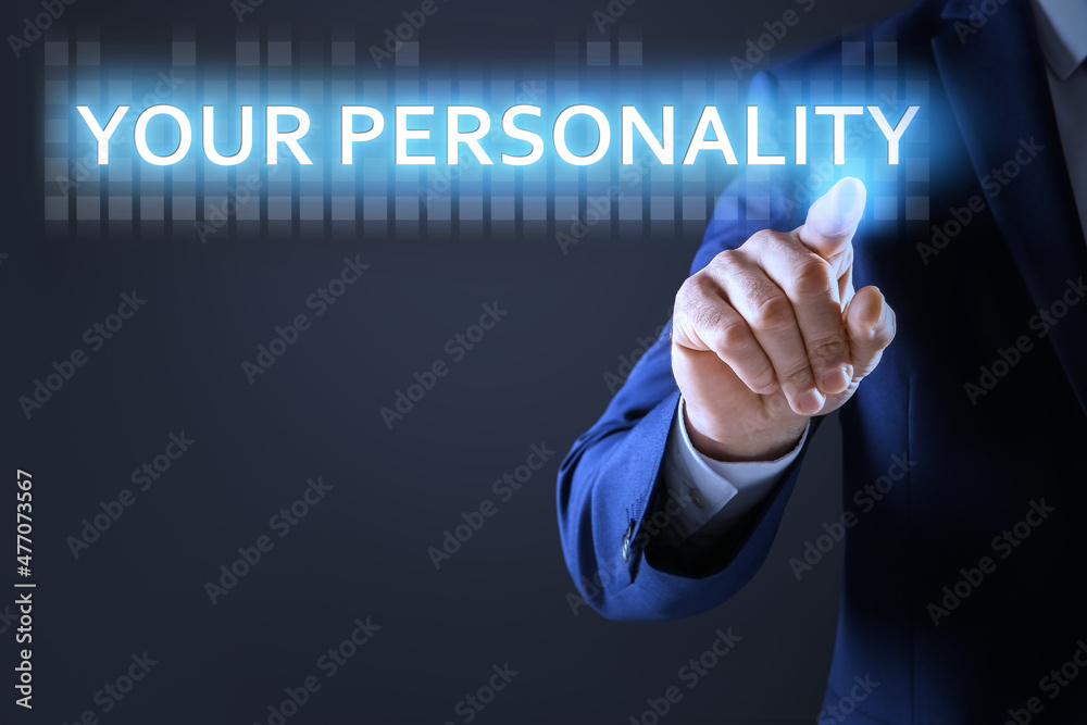 Man pointing at phrase YOUR PERSONALITY on virtual screen against dark background, closeup Man pointing at phrase YOUR PERSONALITY on virtual screen against dark background, closeup