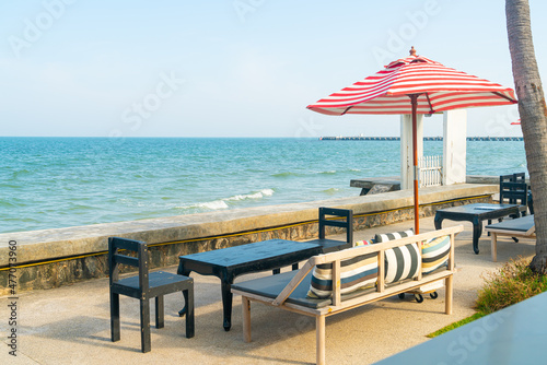 empty bench sofa with umbrella and ocean sea background