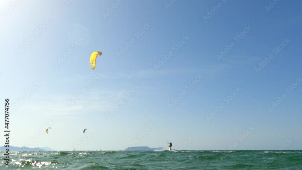 Acrobatic kite surfer training with kitesurf for sport concept and healthy lifestyle. Slow-motion