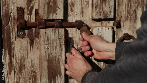 closing an old wooden door from exterior close-up shot