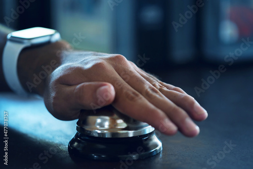 Hand slamming ready bell in a restaurant, hotel or reception