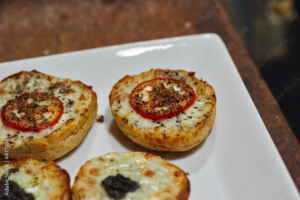 Close up photo of appetizers with mozzarella and tomatoes Close up photo of appetizers with mozzarella and tomatoes