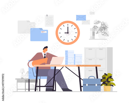 overworked businessman using laptop at workplace busy business man working in office paperwork deadline concept