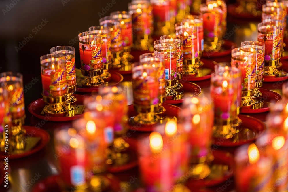 Bangkok, Thailand - December, 20, 2021 : Praying and meditation with burning candle on Chinese temple in Wat Leng Nei Yee 2 Temple at Bangkok, Thailand. Bangkok, Thailand - December, 20, 2021 : Praying and meditation with burning candle on Chinese temple in Wat Leng Nei Yee 2 Temple at Bangkok, Thailand.