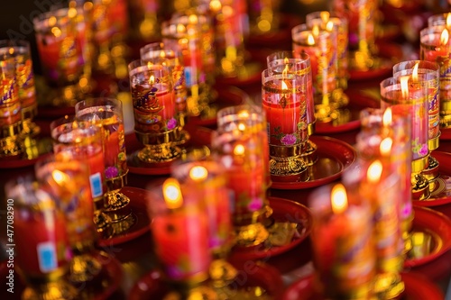Bangkok, Thailand - December, 20, 2021 : Praying and meditation with burning candle on Chinese temple in Wat Leng Nei Yee 2 Temple at Bangkok, Thailand.