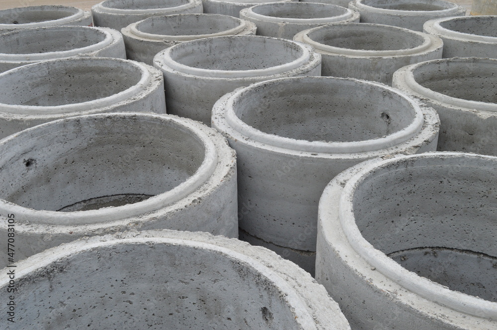 large concrete sewer pipes lined up on the ground large concrete sewer pipes lined up on the ground