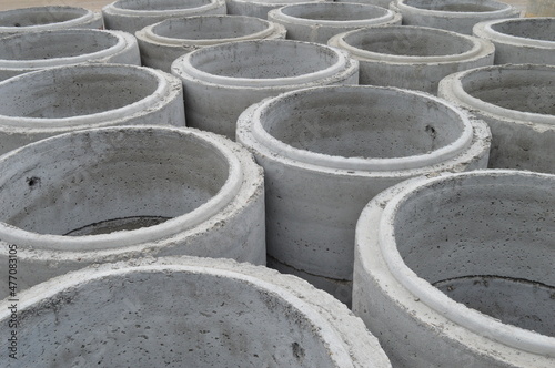large concrete sewer pipes lined up on the ground