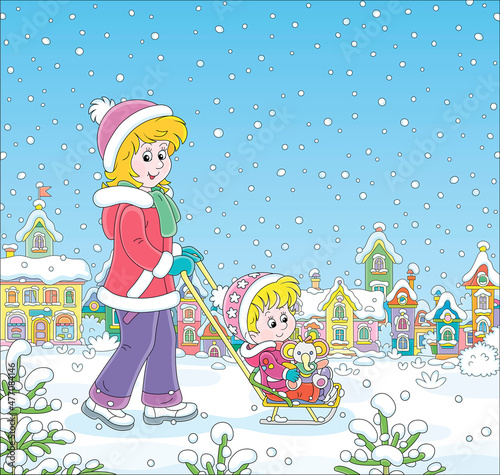 Young cute mom sledding her...