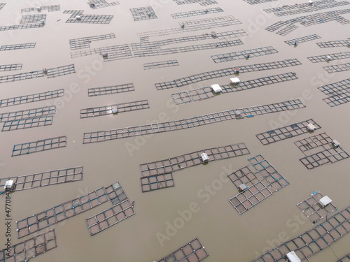 Aerial view of traditional floating fish pond on lake in Indonesia photo