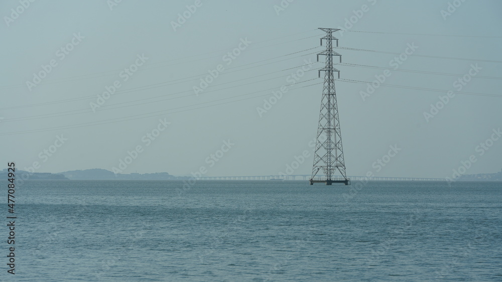 The beautiful lake landscapes with the electronic iron tower across it in spring