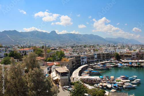 KYRENIA . CYPRUS.View from the fortress on the Cyrenian Harbor, houses of Kyrenia, mountains and blue sky with clouds... photo