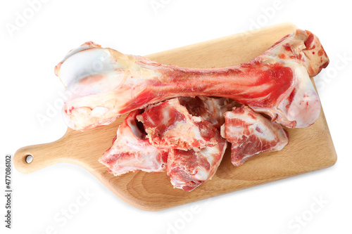 Wooden board with raw meaty bones on white background, top view