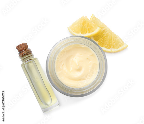 Body cream and cosmetic product with lemon on white background, top view