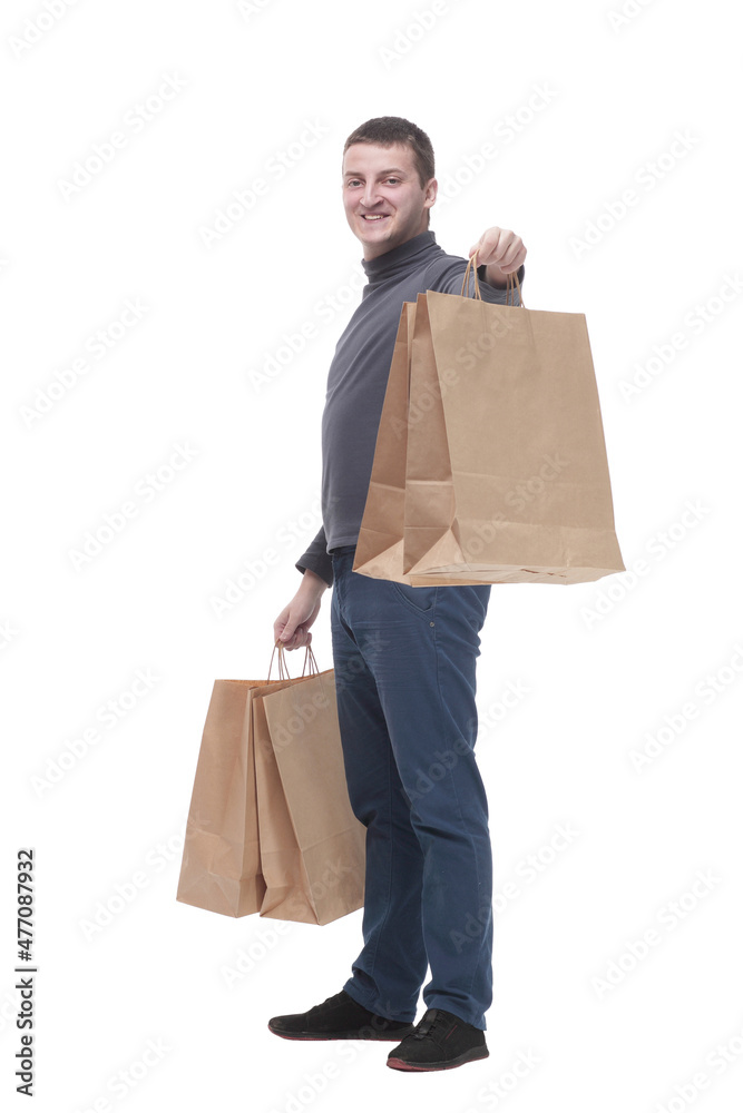 in full growth. casual young man with shopping bags. in full growth. casual young man with shopping bags.