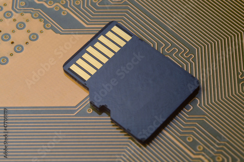 the black micro sd card lies on the microcircuit. close-up.