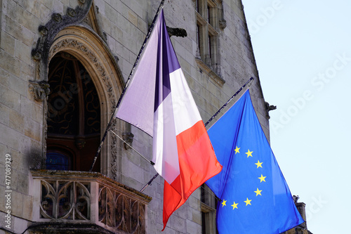 france and european flag on outdoor building wall facade of city hall