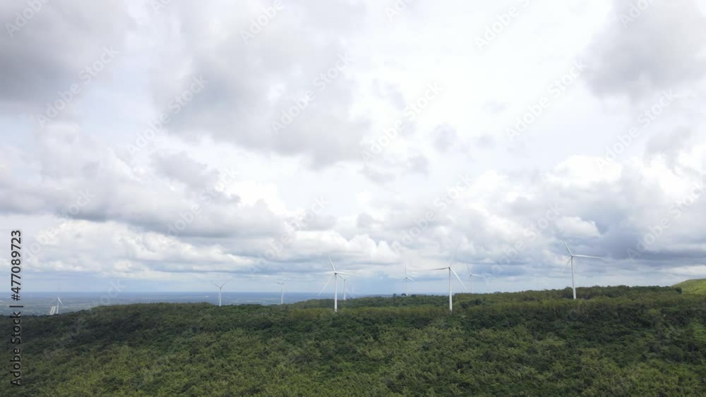 The movement of large clouds. The windmill is spinning with the wind blowing. The movement of large clouds. The windmill is spinning with the wind blowing.