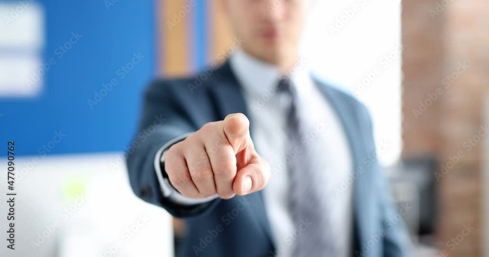 Businessman in business suit points his finger forward