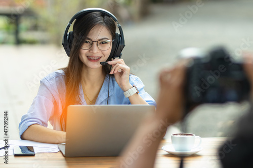 Young friendly female  Asia woman representative operator with a headset working in a call center.