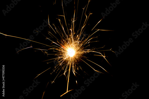 One sparkler on isolated black background