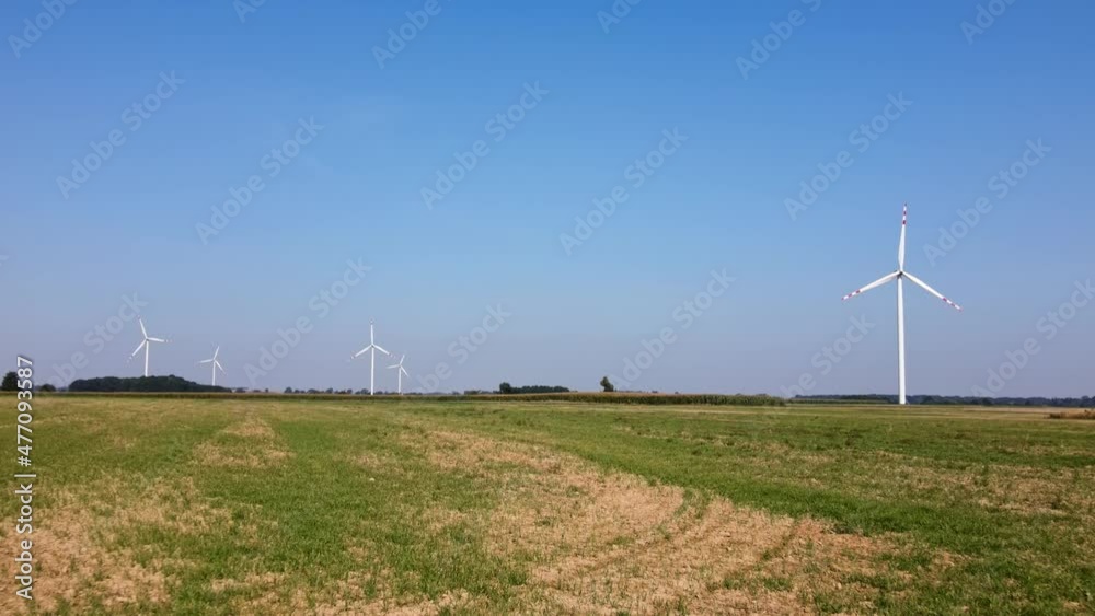 Alternative renewable energy concept, windmill turbines in the field. Aerial view of rotating windmill power generator Alternative renewable energy concept, windmill turbines in the field. Aerial view of rotating windmill power generator