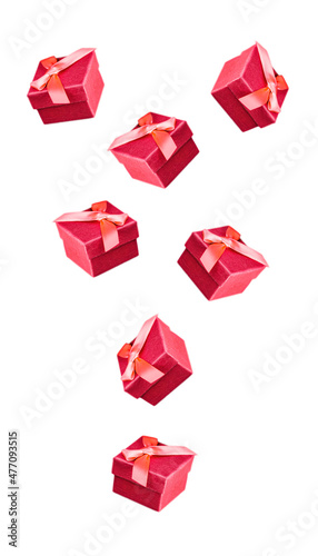 Red presents falling on white solid background