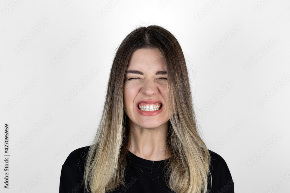 Angry girl screaming. White background. Lifestyle, emotions and advertisement concept. 