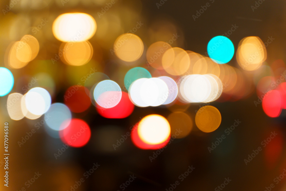 Fototapeta premium Night street lights. Blurred cars, transport and taxis and traffic on the evening city road with bright lights. Evening mood