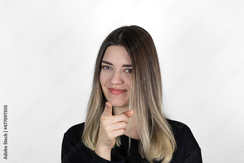 Young beautiful happy woman in studio, pointing at you. Closeup portrait of crazy woman pointing finger at camera. Studio shot, white background. Text, copy and paste space. Young beautiful happy woman in studio, pointing at you. Closeup portrait of crazy woman pointing finger at camera. Studio shot, white background. Text, copy and paste space.