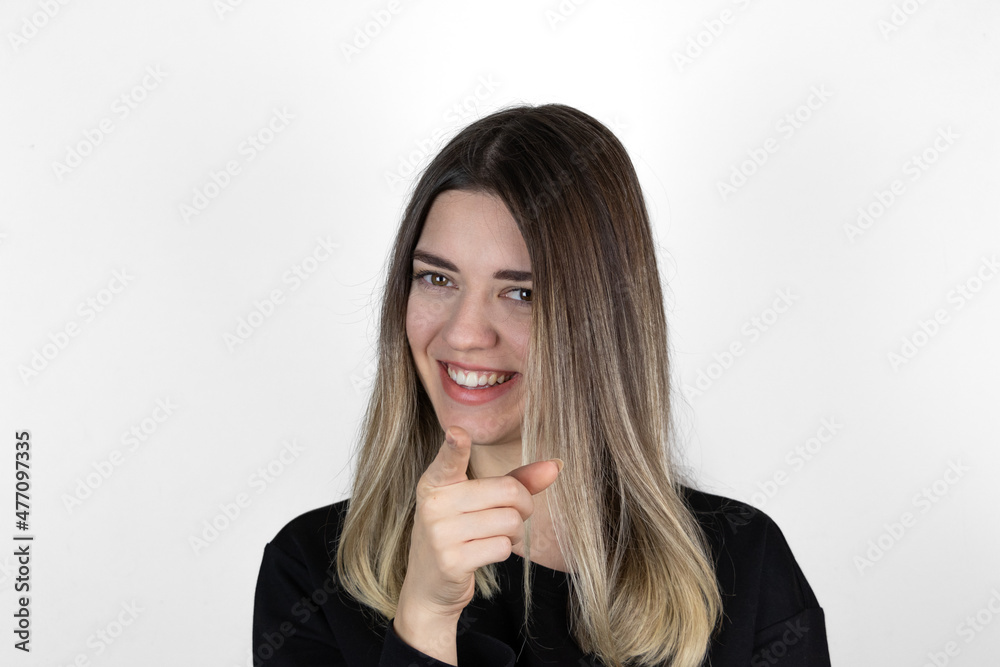 Young beautiful happy woman in studio, pointing at you. Closeup portrait of woman pointing finger at camera. Studio shot, white background. Text, copy and paste space. Young beautiful happy woman in studio, pointing at you. Closeup portrait of woman pointing finger at camera. Studio shot, white background. Text, copy and paste space.