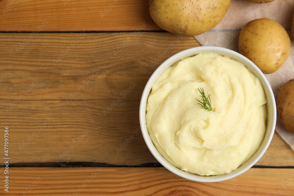 Freshly cooked homemade mashed potatoes and raw vegetables on wooden table, flat lay. Space for text Freshly cooked homemade mashed potatoes and raw vegetables on wooden table, flat lay. Space for text