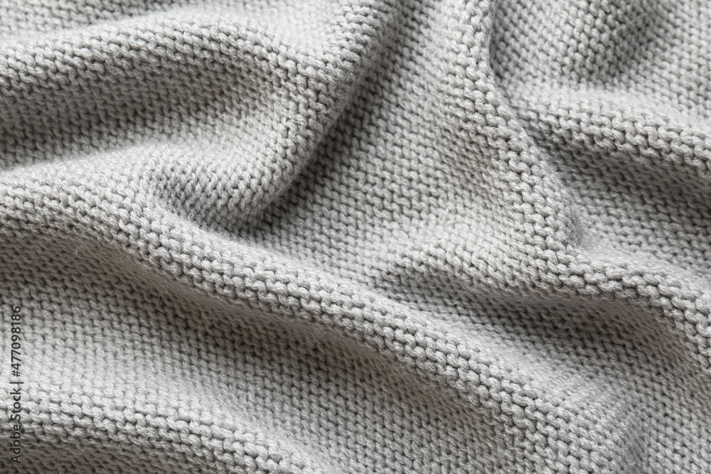 Beautiful grey knitted fabric as background, top view Beautiful grey knitted fabric as background, top view
