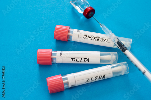 Injection and swab tubes with medical samples against blue background photo