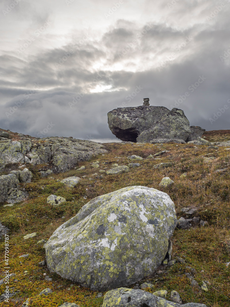Boulders at Hardangervidda plateau with small cairn in background Boulders at Hardangervidda plateau with small cairn in background