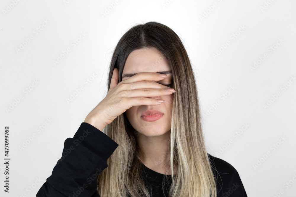 Young blonde girl wearing casual clothes with hand on head for pain in head because stress. suffering migraine. White background. Young blonde girl wearing casual clothes with hand on head for pain in head because stress. suffering migraine. White background.