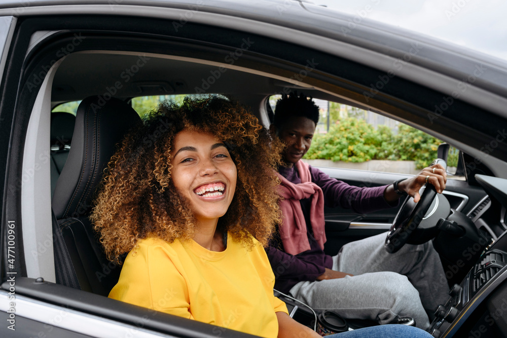 Smiling woman with friend sitting in car Smiling woman with friend sitting in car