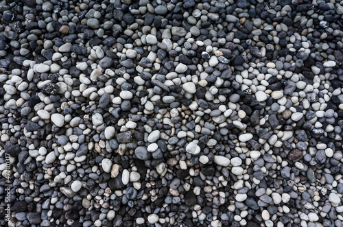 Gray and white pebbles heap at beach photo