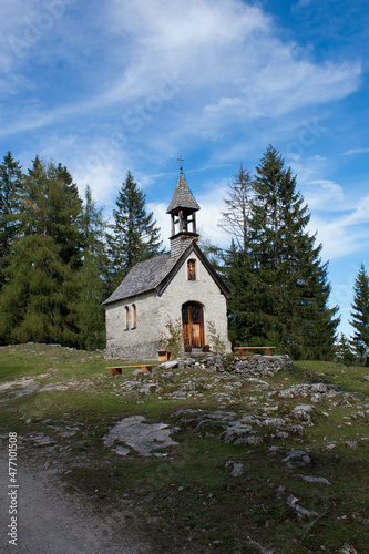 Tiny church in bavaria alps, Germany with blue sky and trees in the background