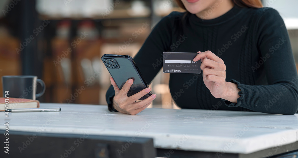 Online payment concept. Young woman online shopping at home, using smartphone and credit card purchase on the internet. Online payment concept. Young woman online shopping at home, using smartphone and credit card purchase on the internet.