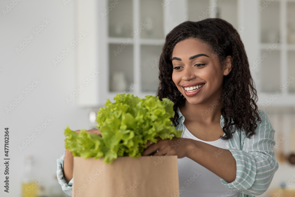 Woman sort organic food after shopping. Online buying and delivery grocery